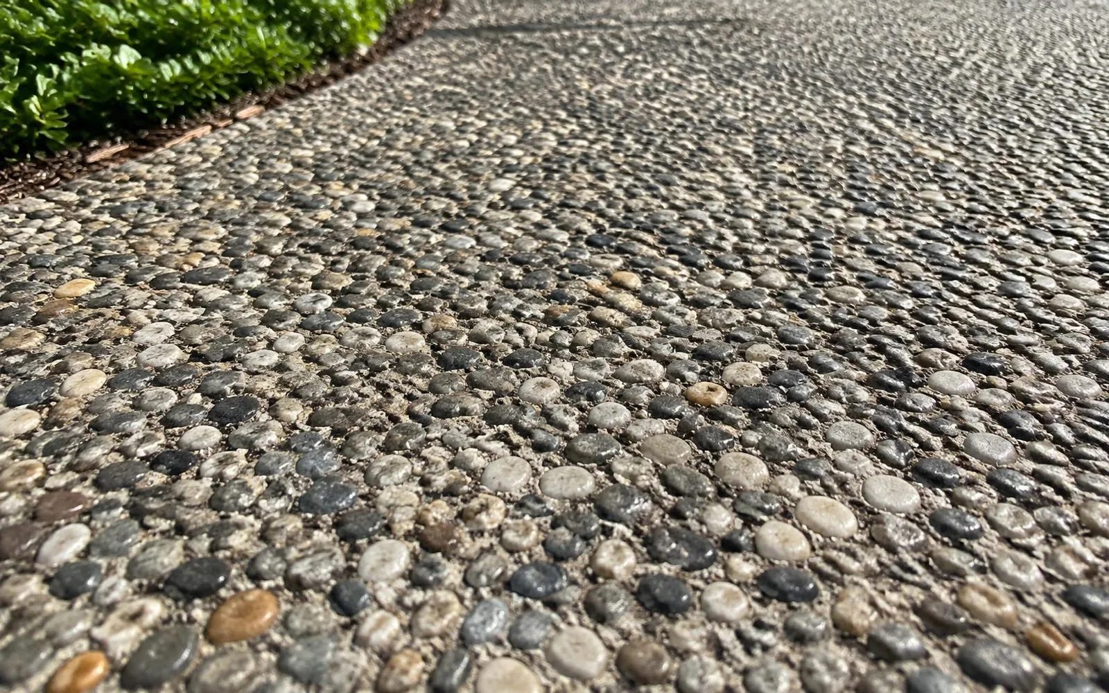 Exposed aggregate concrete surface with small rounded pebbles in Pembroke Pines